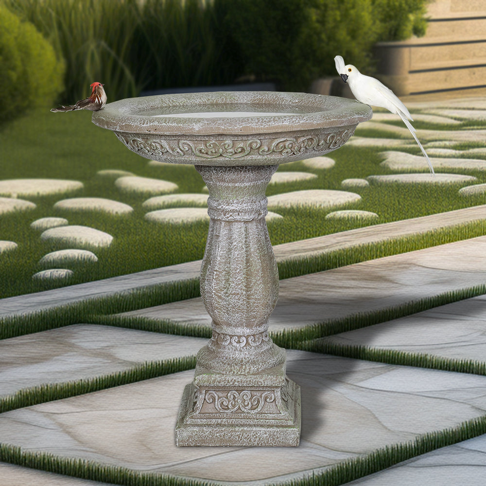 23.8" tall antique pedestal concrete birdbath in a lush traditional garden