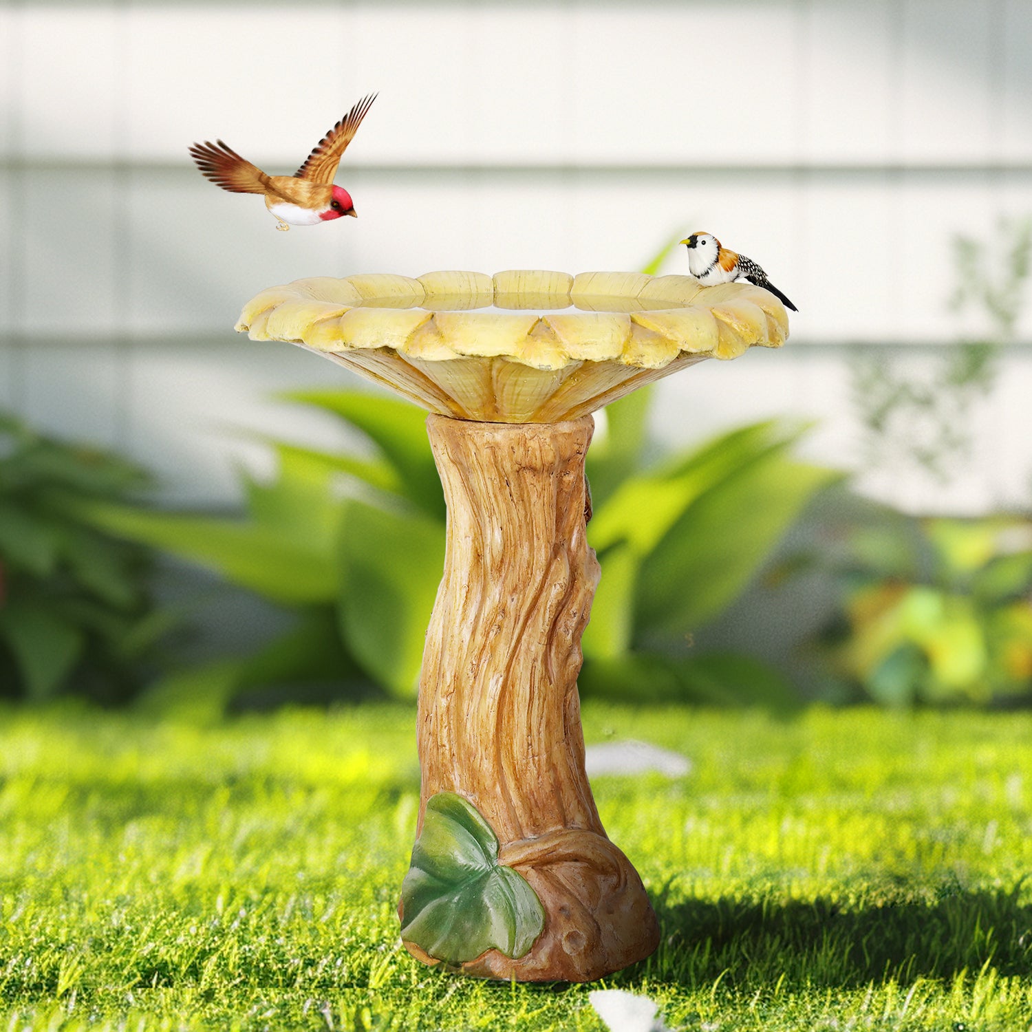 24.4"H concrete sunflower bird bath acting as a charming centerpiece on a green garden lawn