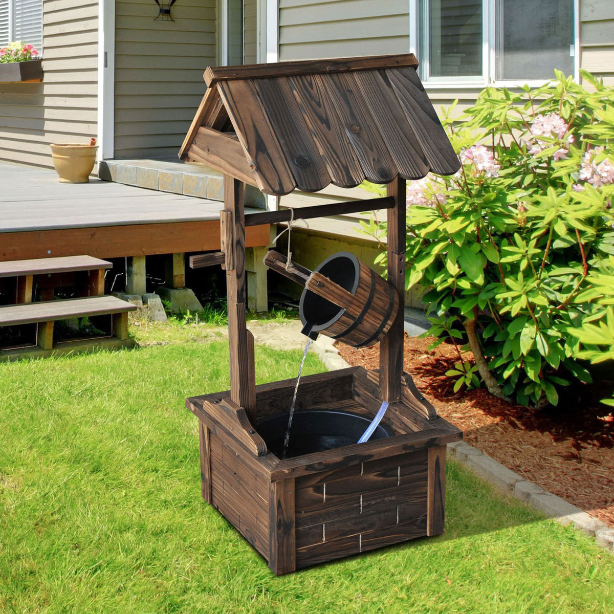 Carbonized Wood Wishing Well Outdoor Fountain 44 Inch in garden setting