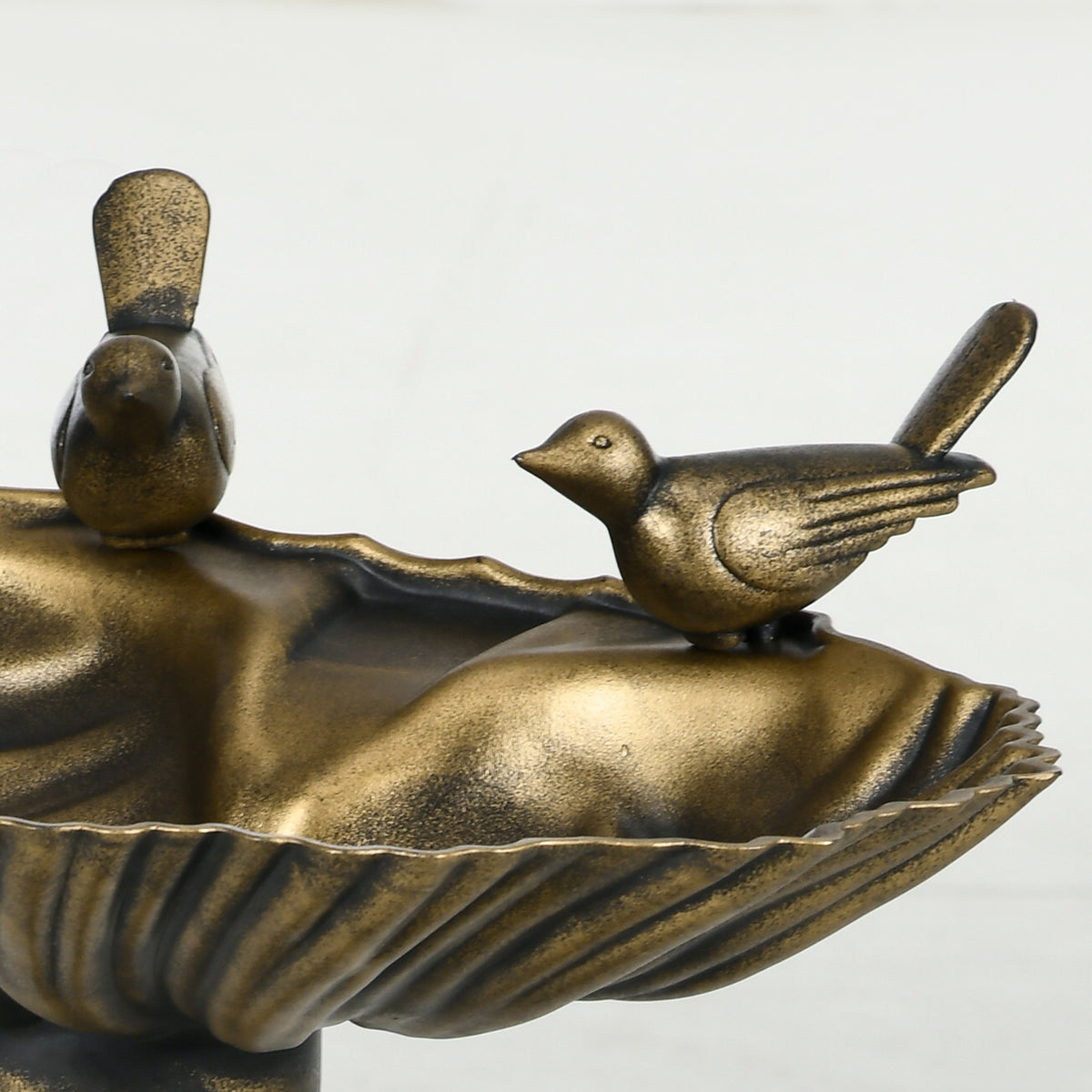 twin sculpted songbirds on shell basin detail of antique bronze bird bath