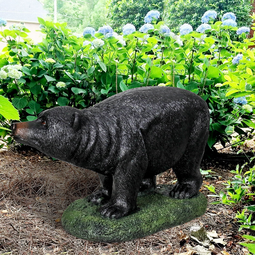 25.5"L realistic black bear garden statue standing proudly on a vibrant green lawn