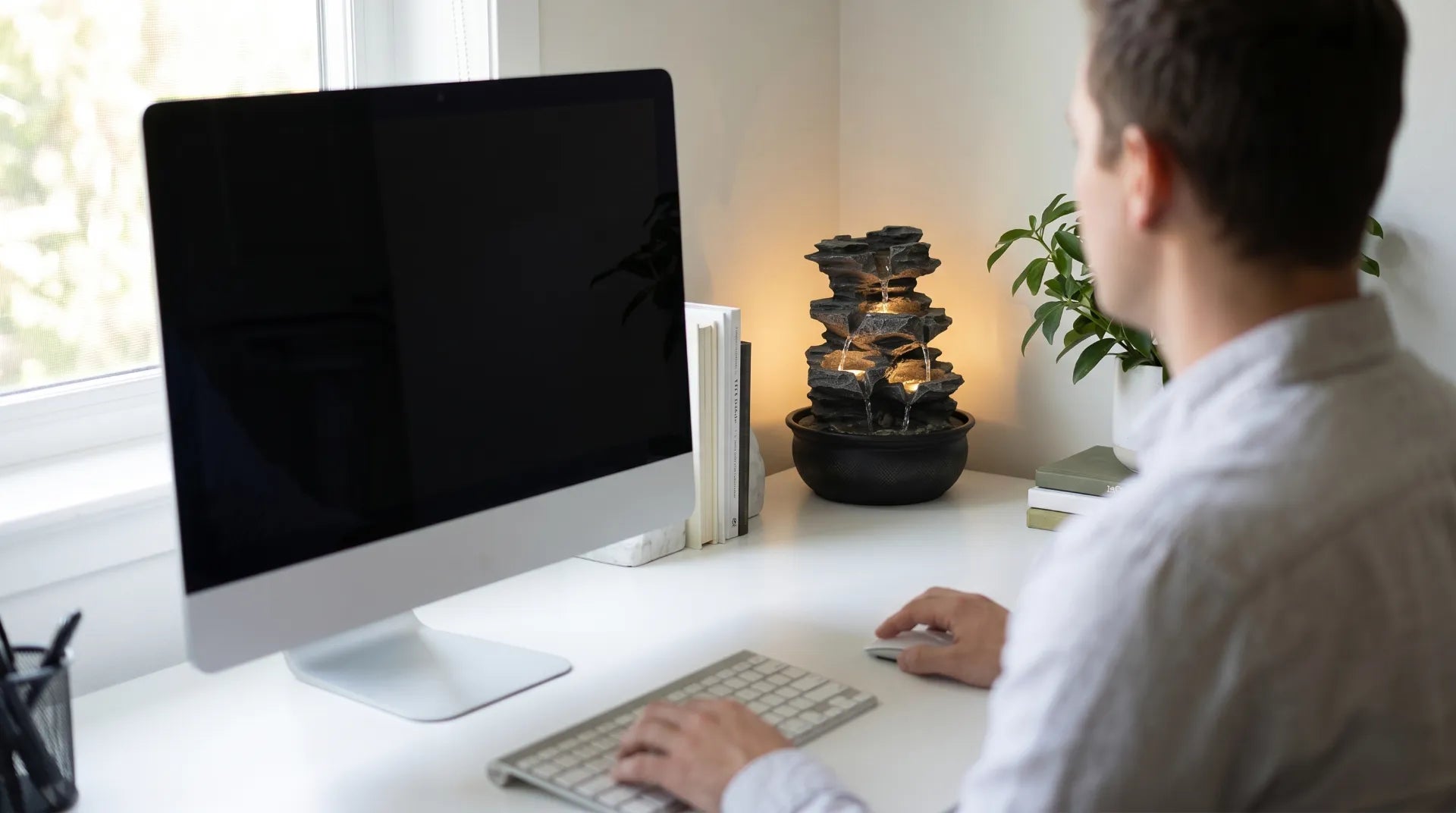 compact desk water fountain back corner home office peripheral vision calm workspace