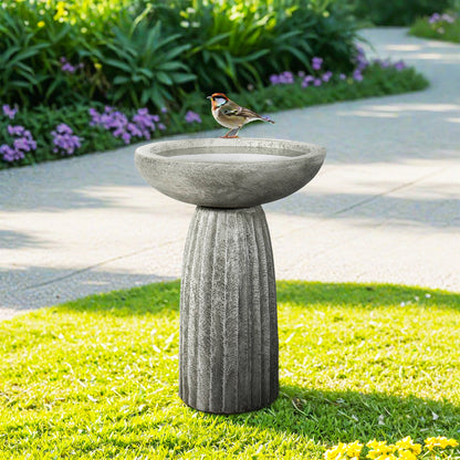 24-inch fluted concrete pedestal bird bath with sparrow on basin in sunny garden