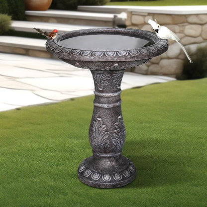 24.4" tall classic pedestal concrete birdbath in a traditional garden