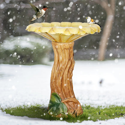 Frost-resistant 24.4"H concrete sunflower bird bath standing durably in a beautiful snowy winter garden.