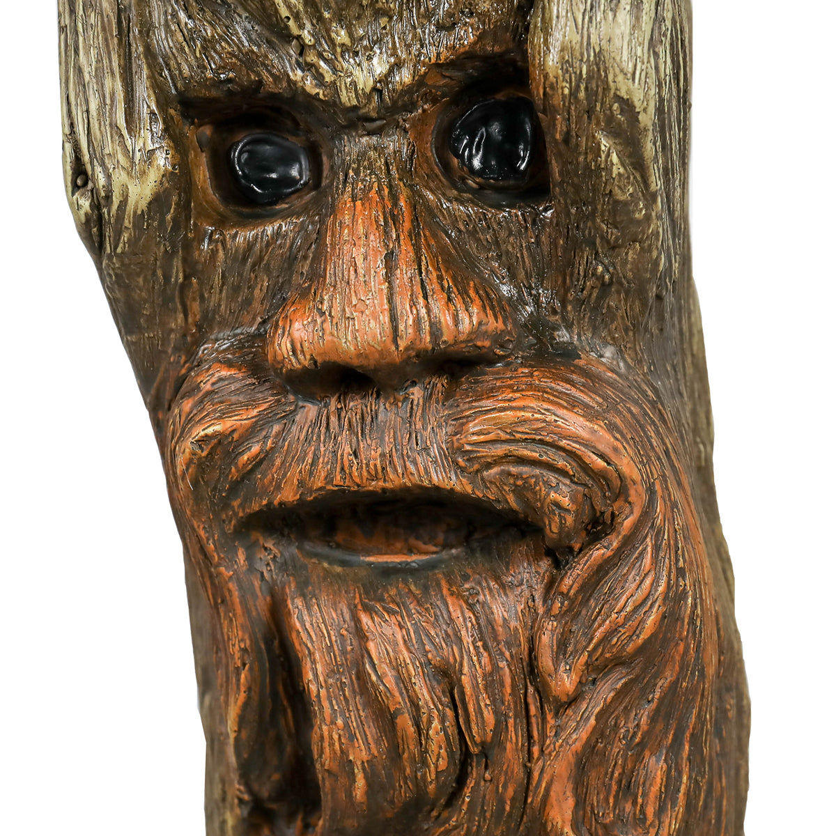 Intricately sculpted "Old Man" tree spirit face on the pedestal of the whimsical garden birdbath.
