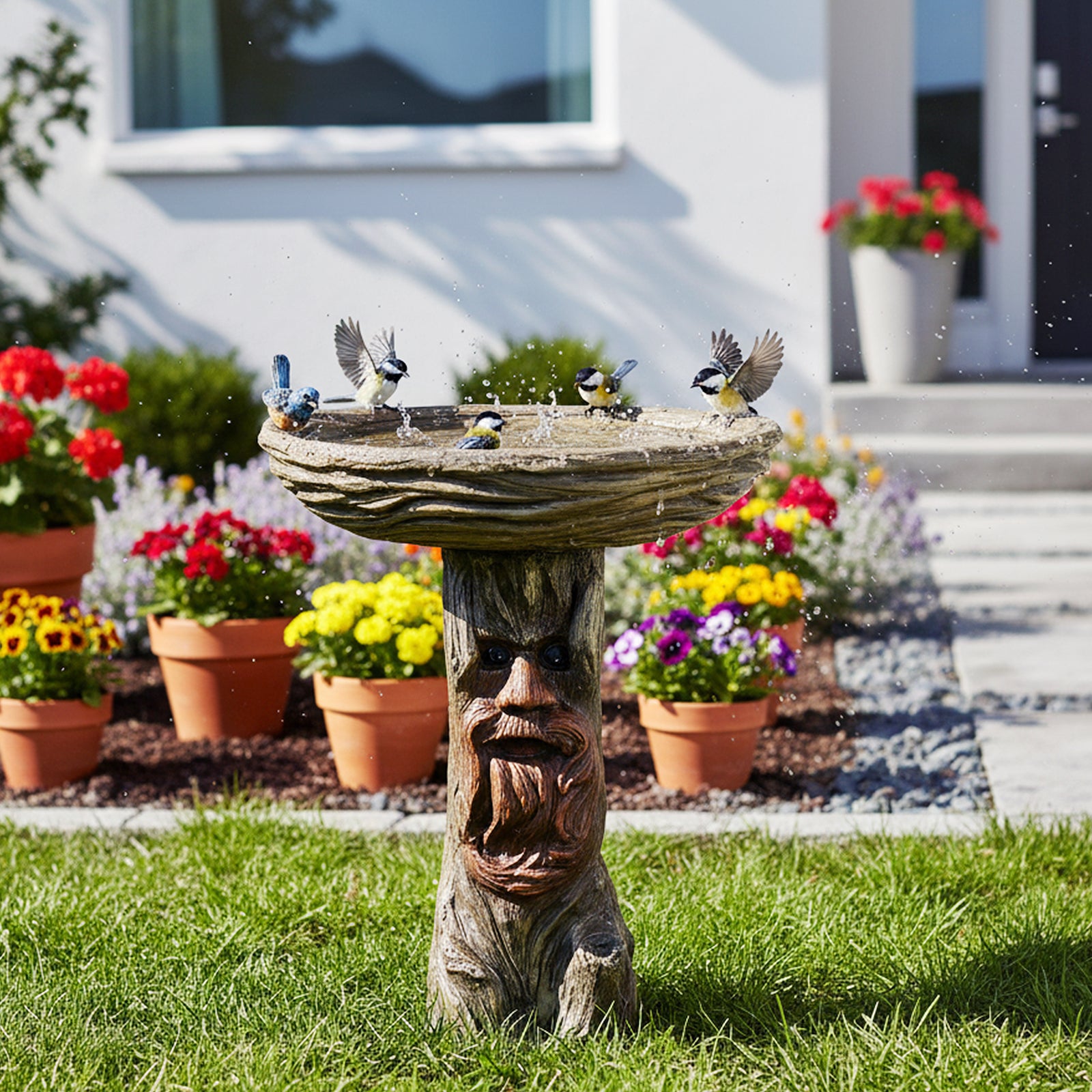 Rustic forest spirit bird bath with realistic tree bark texture decorating a beautiful home backyard lawn.