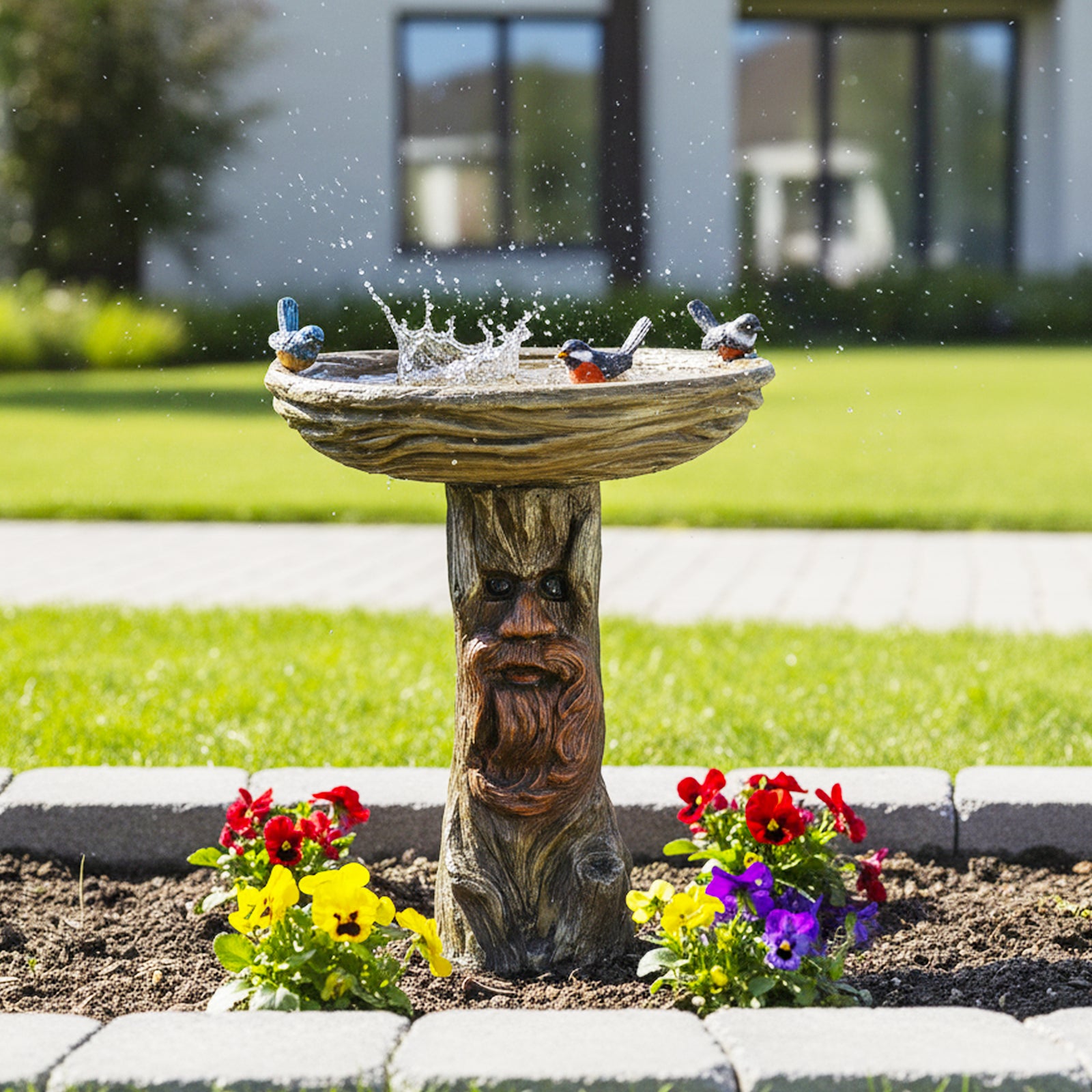 Sturdy 13.4kg whimsical tree spirit birdbath standing elegantly on a stone-paved garden patio path.