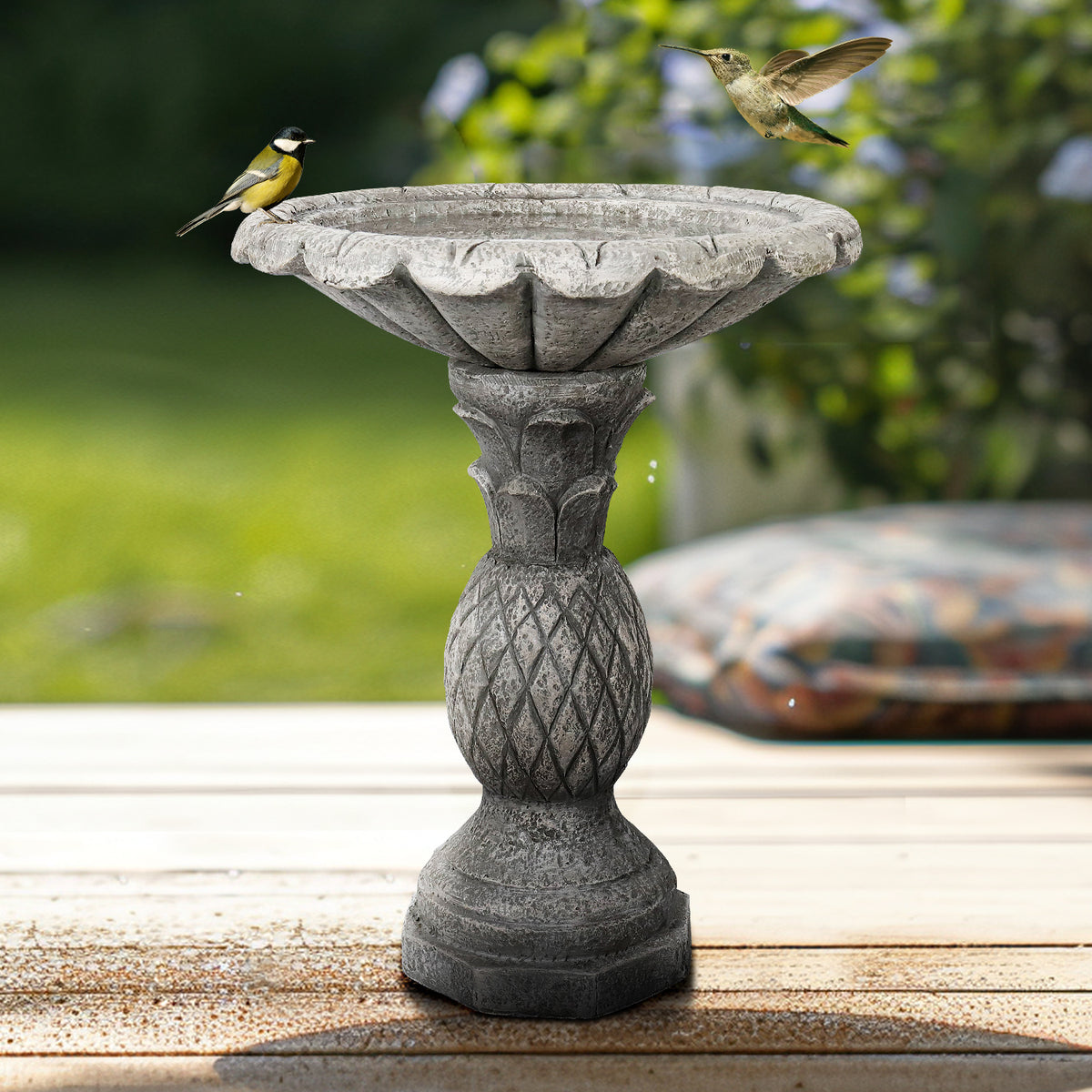 Vibrant birds flying towards the welcoming 18.7" wide bowl of the pineapple texture garden bird bath.