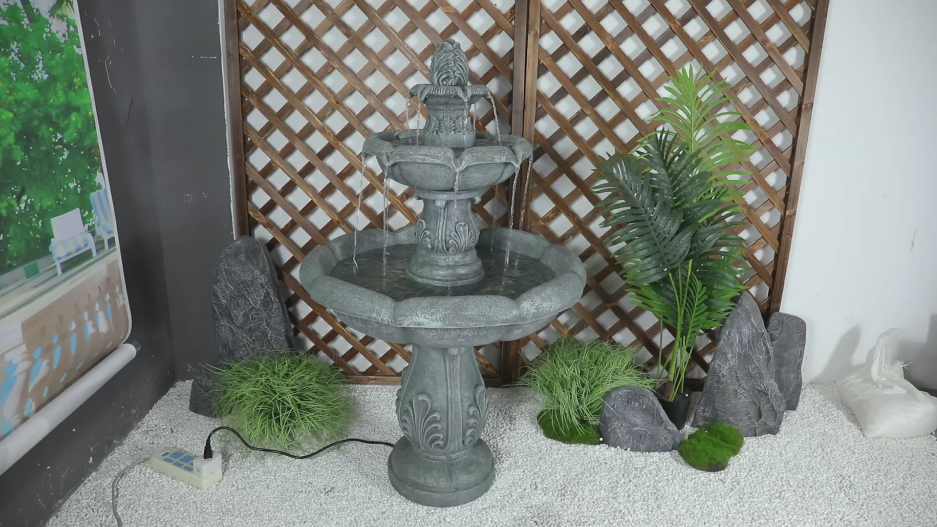 Water flowing through the ornate tiers of a concrete pedestal fountain