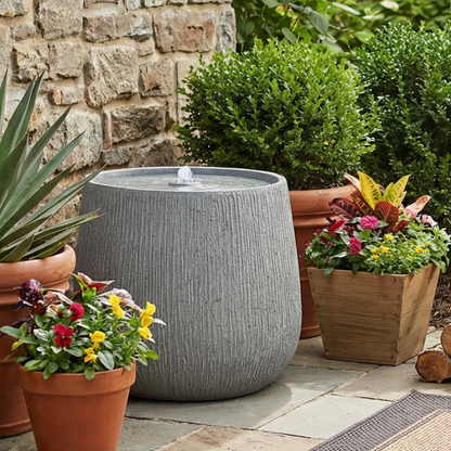 Resin Bubbler Fountain Outdoor Rippled Drum in garden setting
