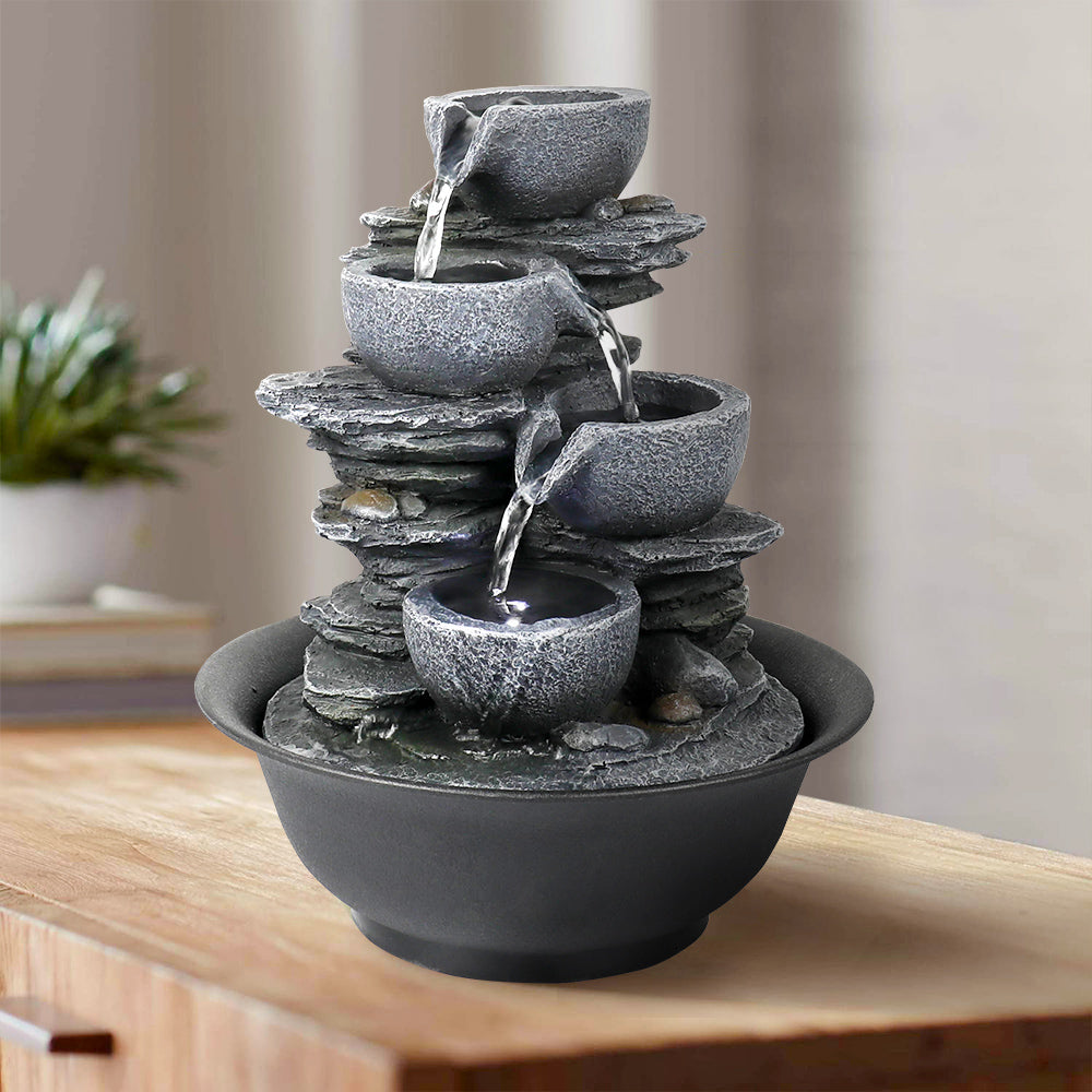 Four stacked bowls with warm accent light.