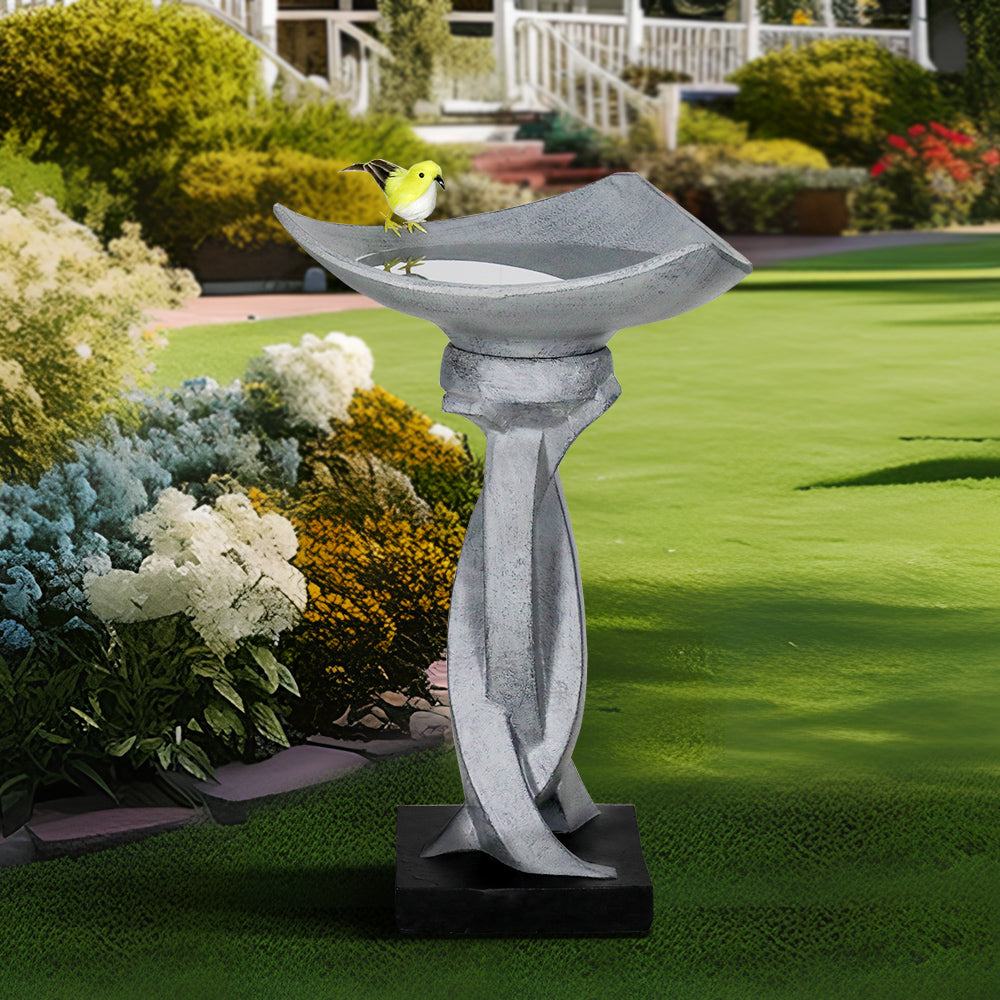 22.8"H modern concrete lotus birdbath acting as a stunning centerpiece in a vibrant outdoor garden