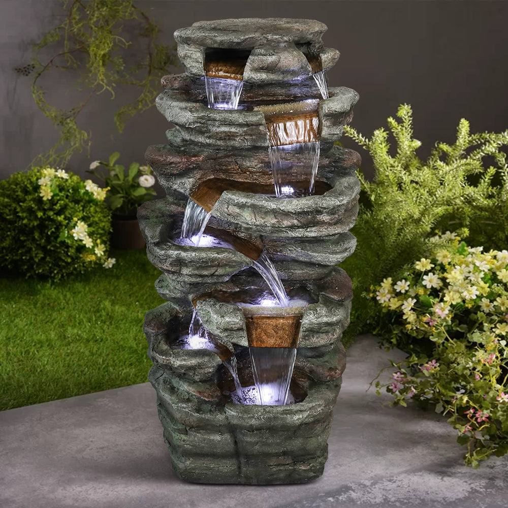 Resin Serpentine Slate Column Cascading Outdoor Fountain LED lit at night