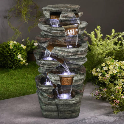 Resin Serpentine Slate Column Cascading Outdoor Fountain LED lit at night
