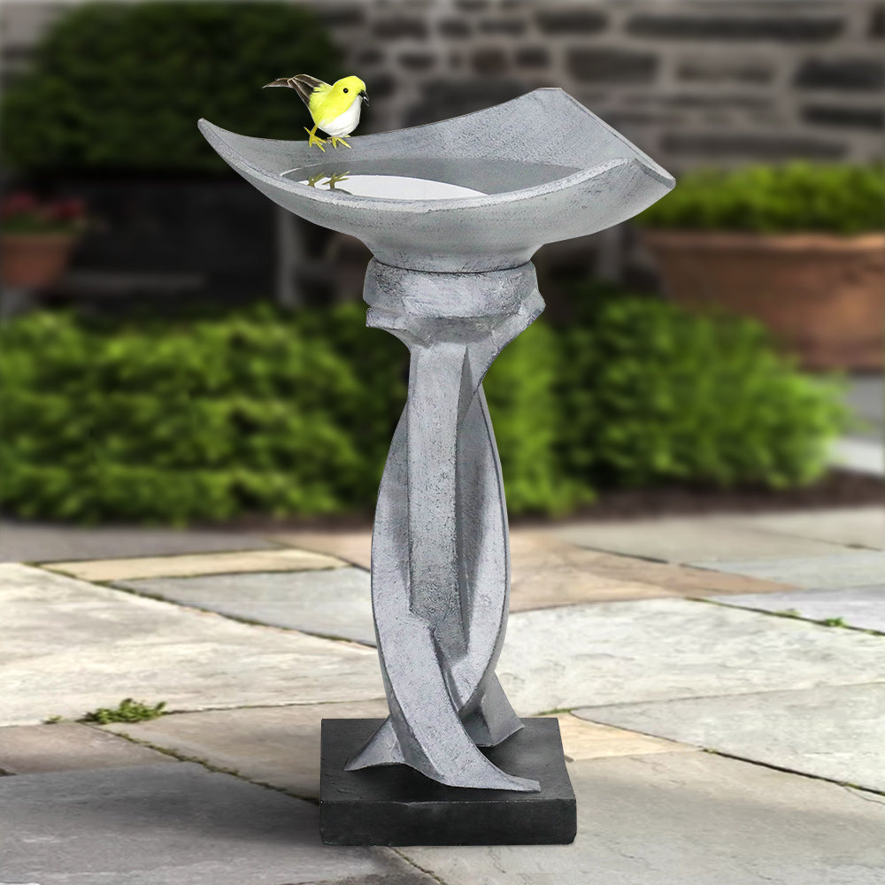 Contemporary geometric pedestal bird bath bringing life and style to a backyard patio setting